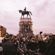 Protesters raise their fists in the air at the Robert E. Lee Statue on June 23, 2020 in Richmond, Virginia. While Virginia Governor Northam has ordered the statue to be taken down, a Richmond judge has issued an injunction temporarily blocking its removal.